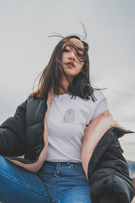 Thy in a white shirt and jeans with a black jacket.